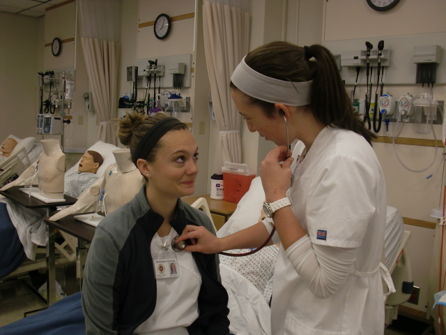 Students practice taking vital signs in the Nursing lab.