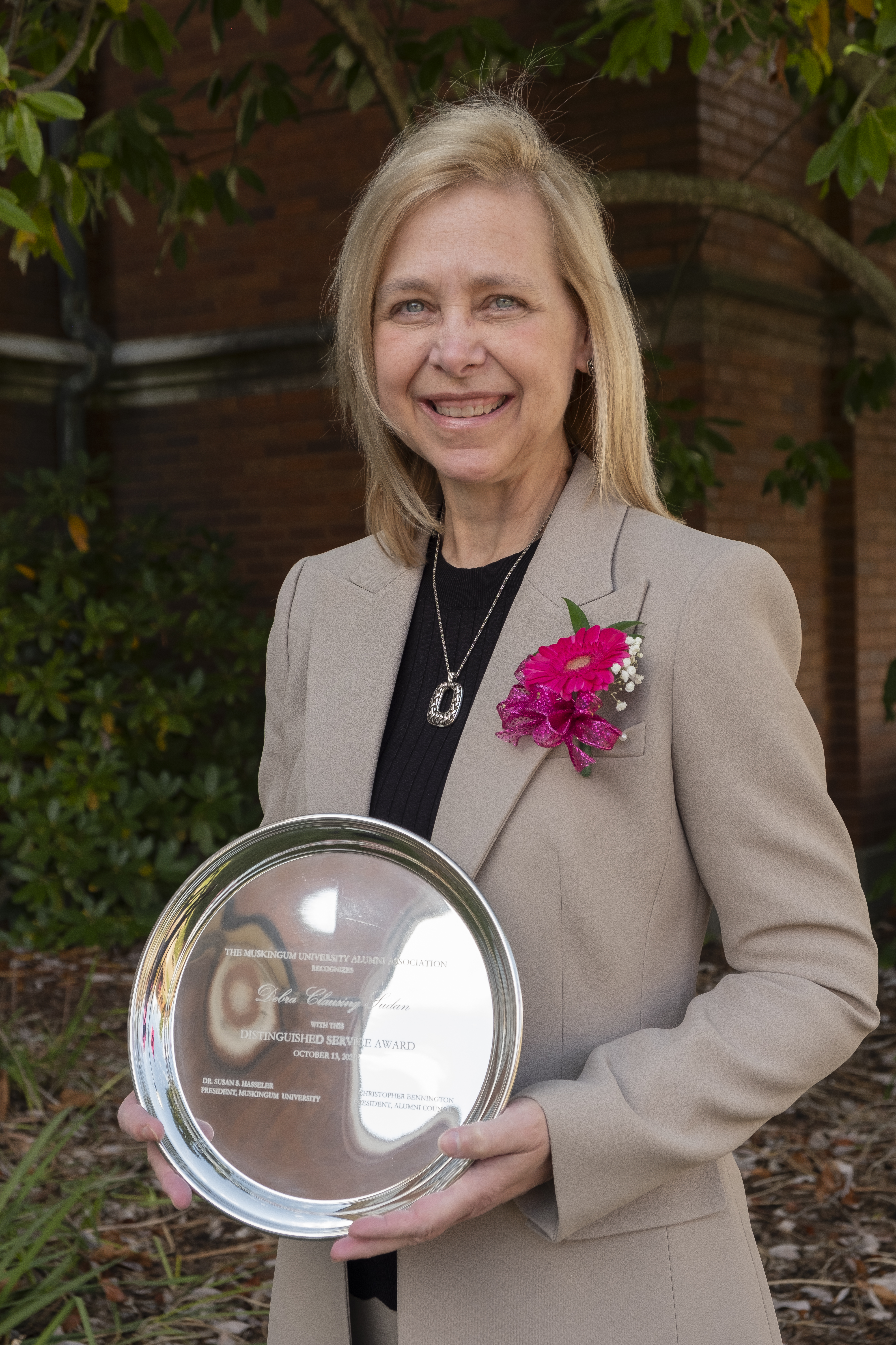 Debra Clausing Sudan posed with her Muskingum University Distinguished Service Award. 