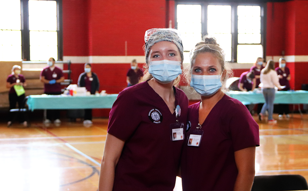 nursing students posing in front of the flu shot clinic