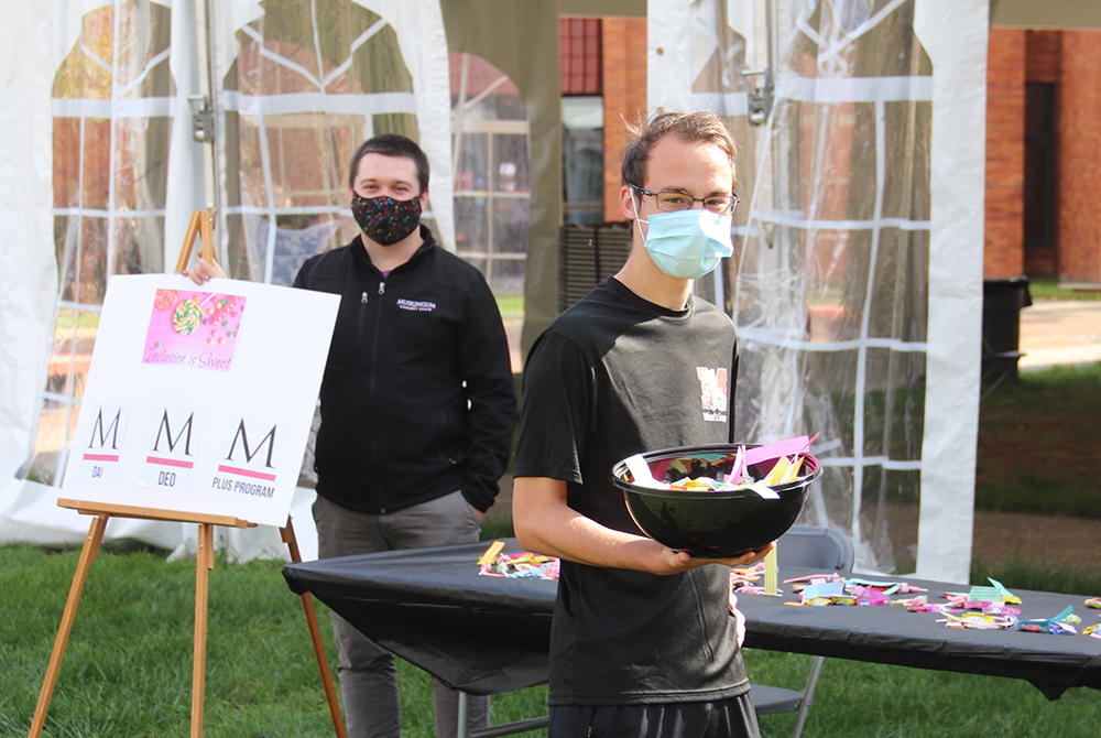 students handing out candy on the quad as part of the Inclusion is Sweet event for Disability Awareness and Inclusion month