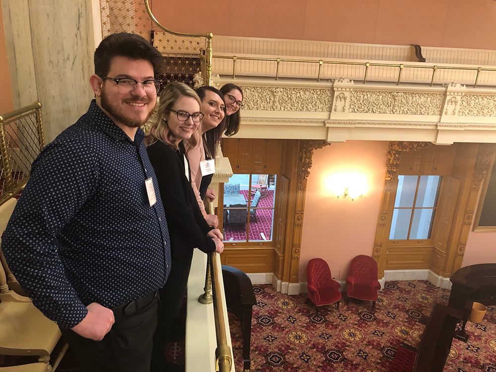 Nate Binni, Rachael Essex, Lorene Kelley, and Zoey Stenson pictured in the lobby of the Ohio Statehouse