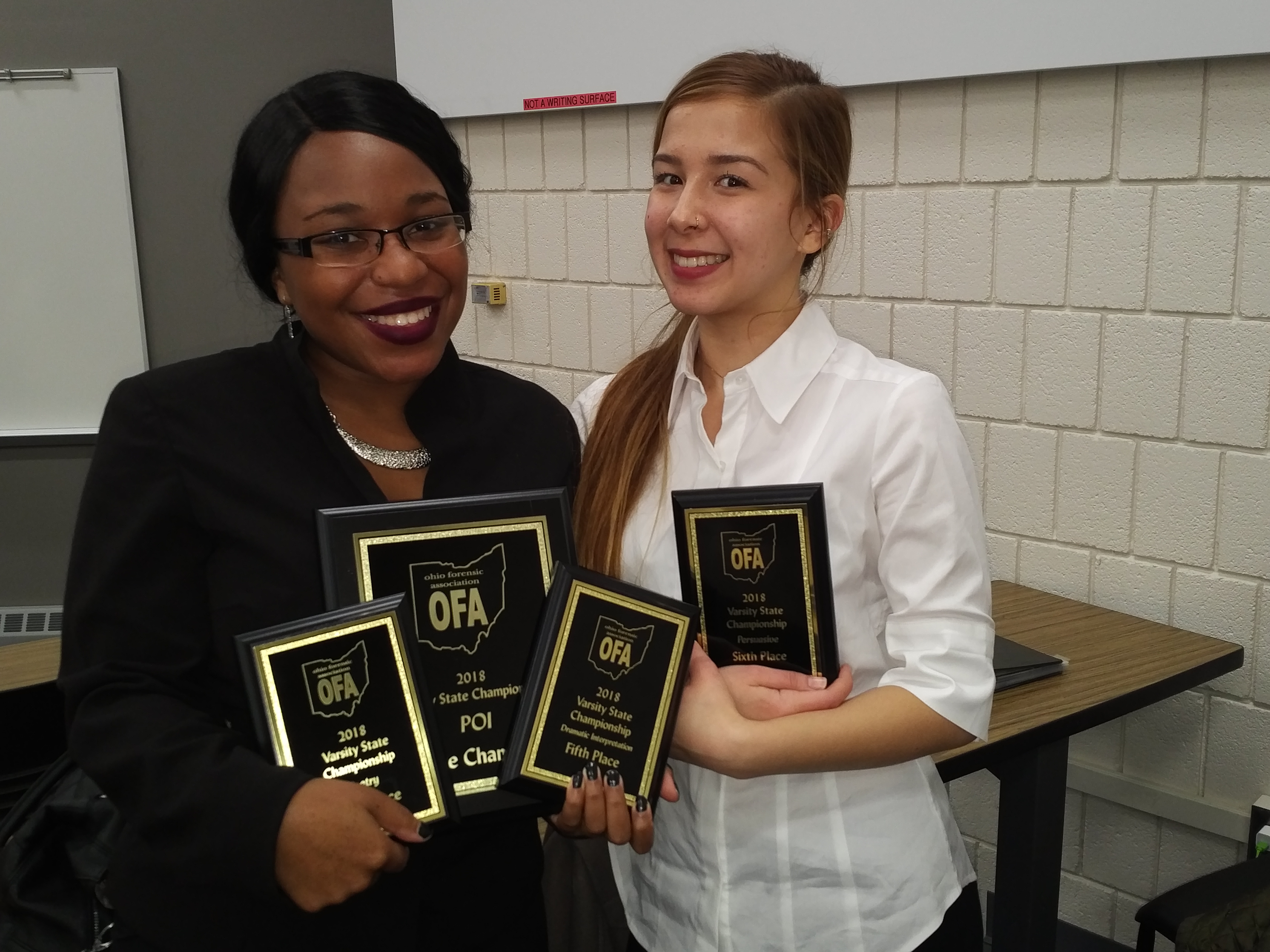 forensis students holding their plaques after winning a competition