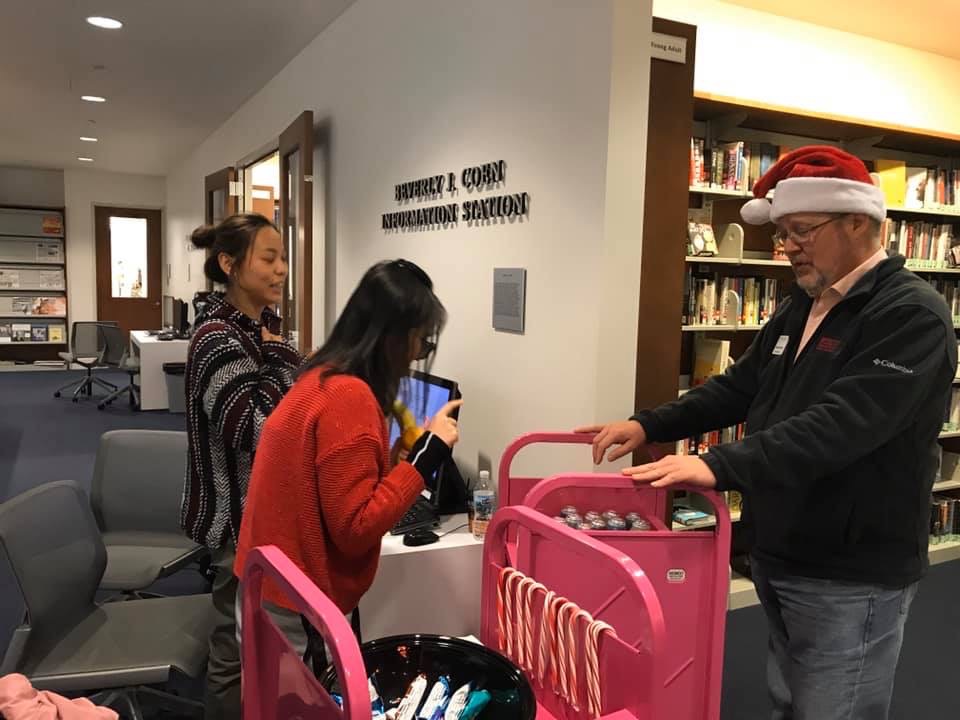 Michael Malone, associate VP of Student Affairs handing out snacks in the library
