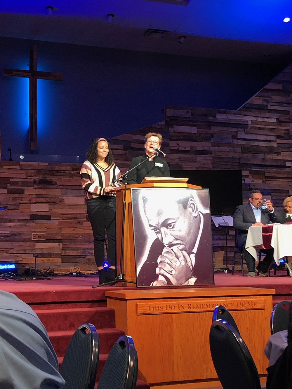 MLK scholarship winner at podium with President Hasseler