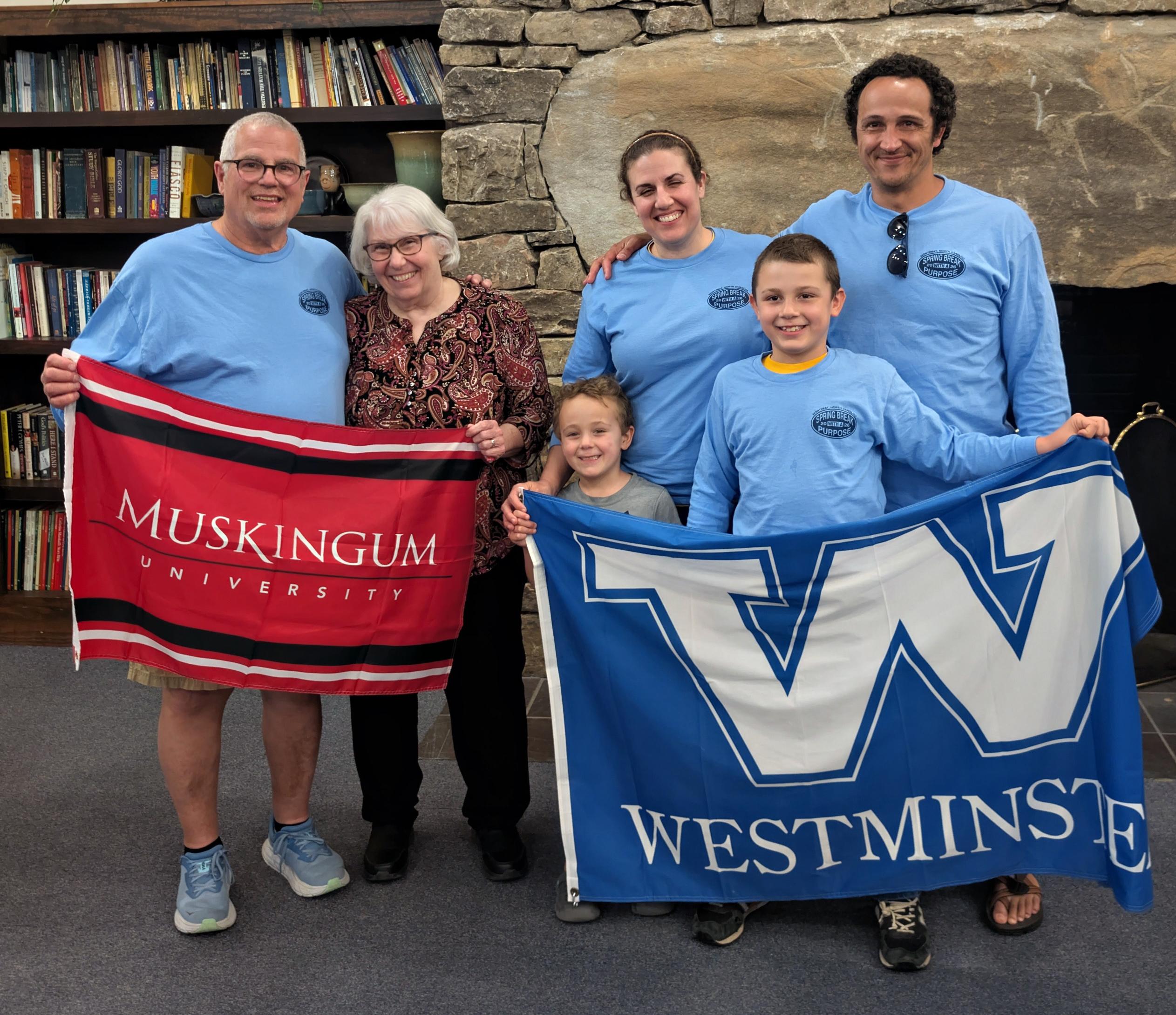 Jim and Jill Mohr, holding the Muskie flag, and their&nbsp;daughter Angie and her husband, along with Jonny and Jacob Urban, are holding the Westminster flag.