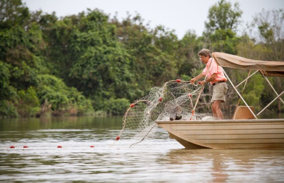 Tim Berra casting a net