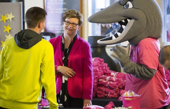 susan hasseler talking to a student with the Muskie Mascot beside her