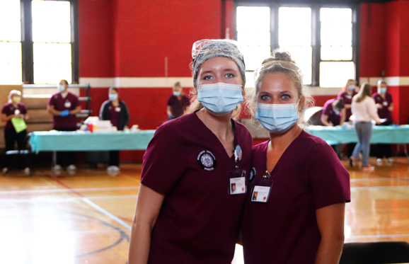 nursing students posing in front of the flu shot clinic