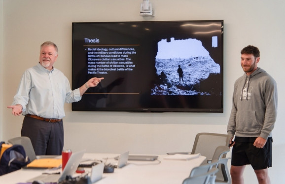 Dr. Thomas McGrath with Student presenting