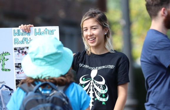 Student talking to another at one of the tables at the Involvement Fair.