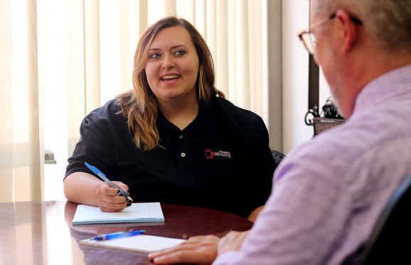zoey stenson in a meeting wearing her black Student Senate polo