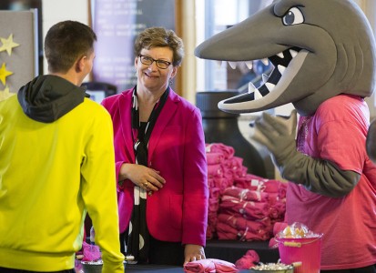 susan hasseler talking to a student with the Muskie Mascot beside her
