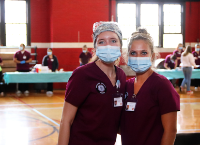 nursing students posing in front of the flu shot clinic