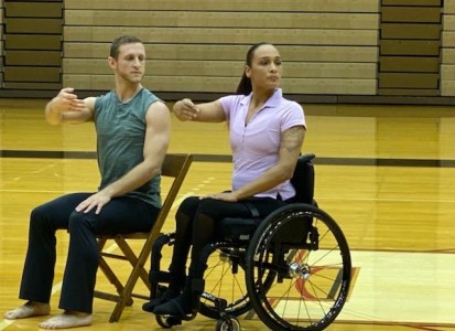 2 dancers in the Anne C. Steele Center performing, one female in a wheel chair, the other, male, sitting in a chair