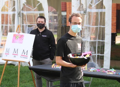students handing out candy on the quad as part of the Inclusion is Sweet event for Disability Awareness and Inclusion month