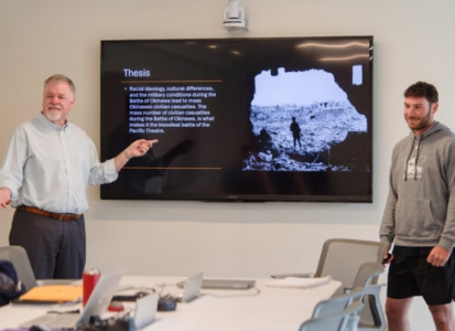 Dr. Thomas McGrath with Student presenting