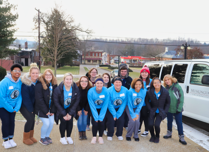 Group of students in front of Muskingum University van getting ready to deliver food to the local food pantry