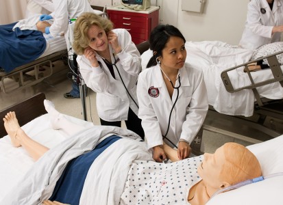 nursing student and instructor examining a practice dummy patient in the Muskingum Nursing Lab