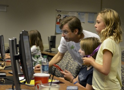 Professor Shaffstall working with students on a computer