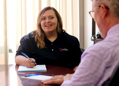 zoey stenson in a meeting wearing her black Student Senate polo