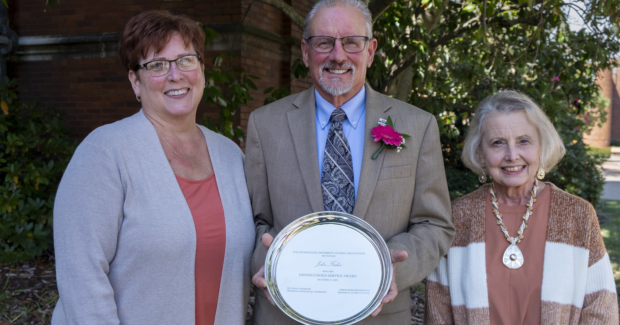 John Fisher and his family posed with his Muskingum University Distinguished Service Award.  
